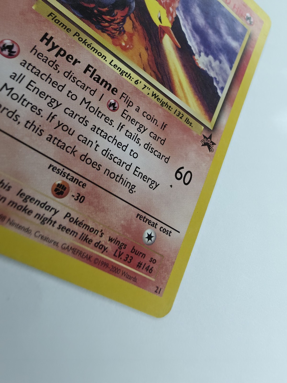 Moltres, front gloss under raking light, attack text with the 60