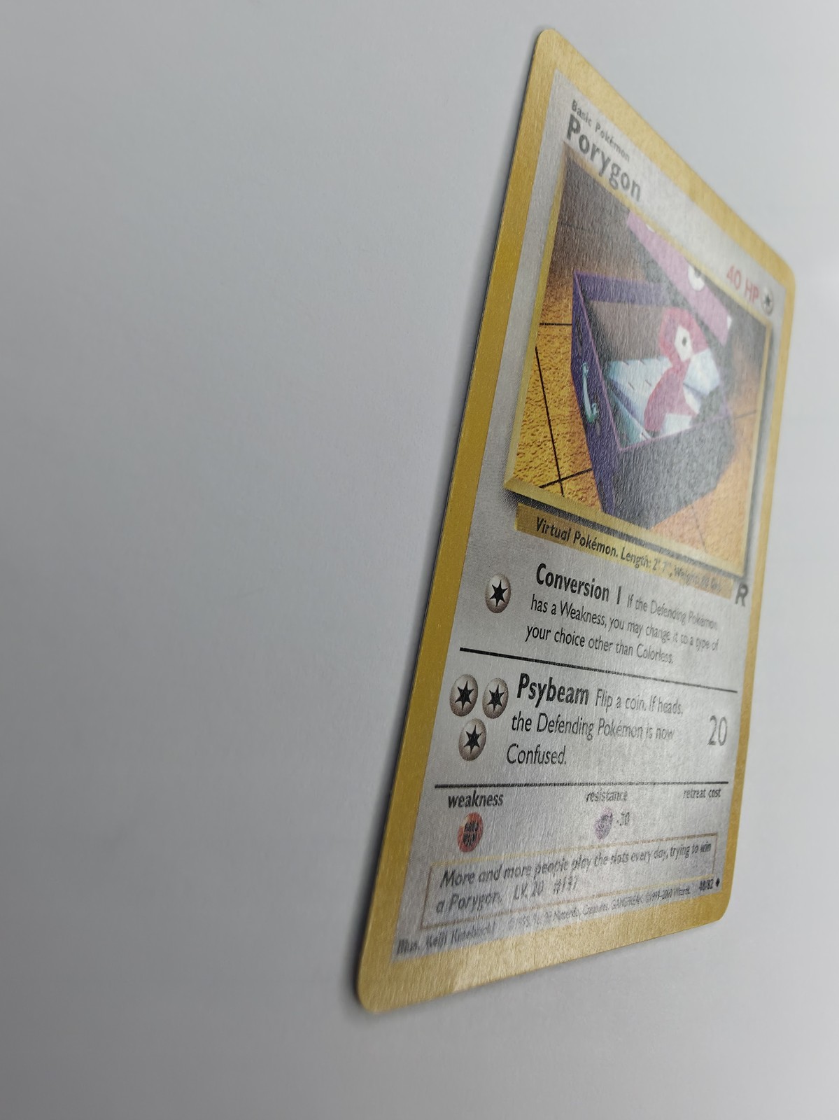 Porygon, front gloss under strong raking light across art, text box and right border
